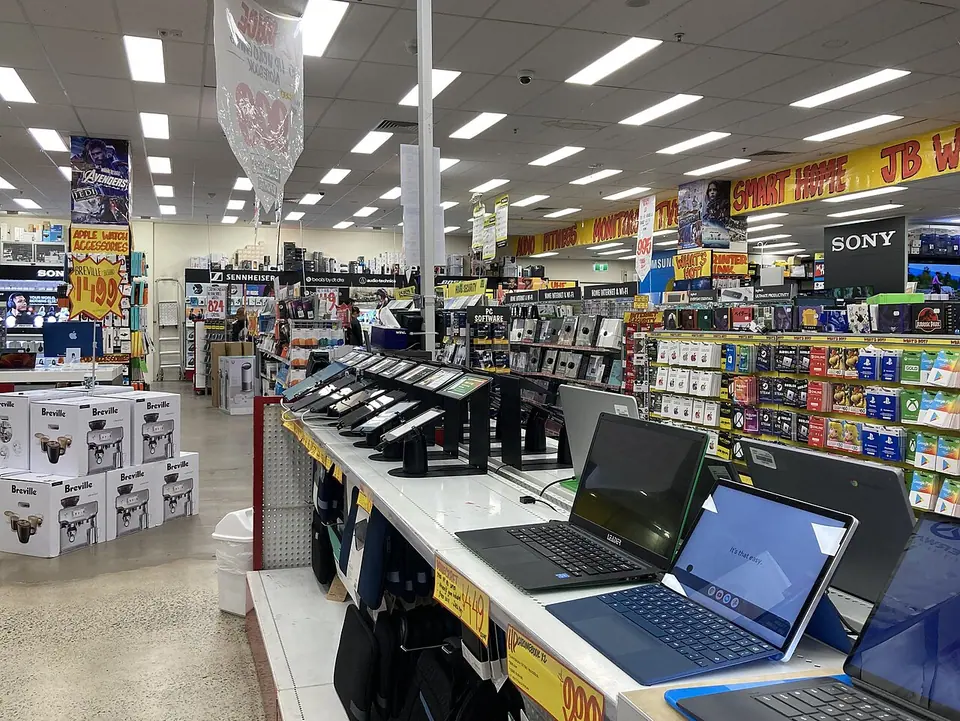 Laptops and computer products displayed in a retail store.