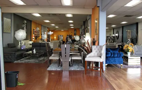 Tables, chairs and other furniture displayed in a showroom.