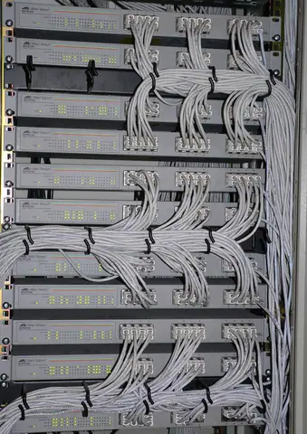 Network switches and patch cables in a rack.