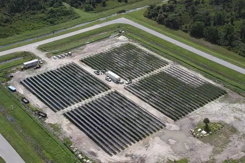 Rows of photovoltaic panels at a solar power installation.