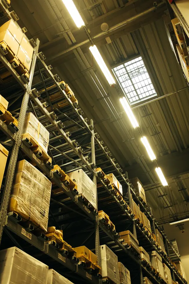 High warehouse shelves holding packaged stock.